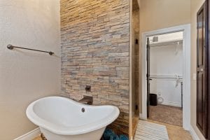 rental house bathroom with large bath tub, and walk in closet